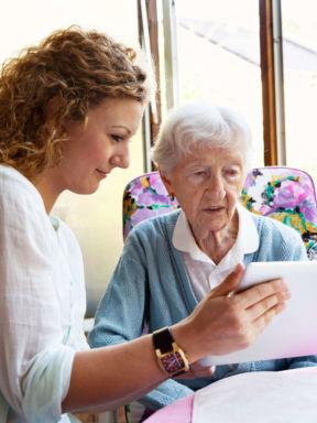 a social worker helps assist an elderly woman
