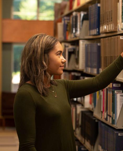 A female student looks for a library book